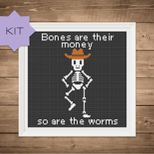 May include: A cross-stitch pattern featuring a skeleton wearing a cowboy hat and the text "Bones are their money so are the worms".