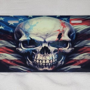 May include: A white skull with red, white, and blue paint splatters, set against a backdrop of an American flag.