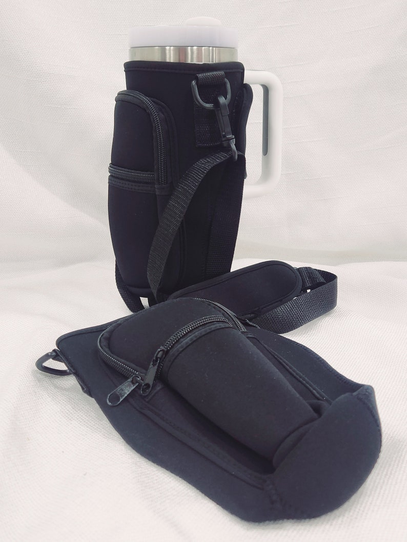 May include: Two black neoprene insulated beverage holders with zippered pockets and adjustable straps. One holder has a white handle.