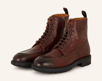May include: Brown leather lace-up boots with a chunky sole and a zipper on the side.