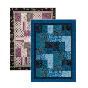 May include: Two quilt patterns, one in shades of purple and green, the other in shades of blue. Both quilts feature a patchwork design with various geometric shapes.