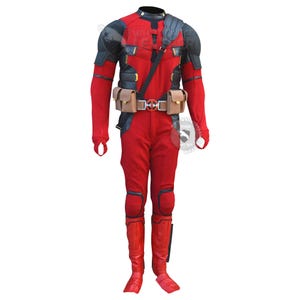 May include: A full-body red and black tactical costume featuring a utility belt with two tan pouches and a central circular buckle with a red and silver emblem. The suit includes black shoulder armour, long sleeves with thumb holes, and red leg guards.