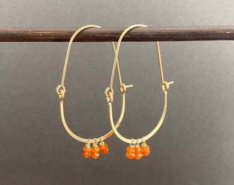 Gold gemstone oval hoop earrings with orange carnelian