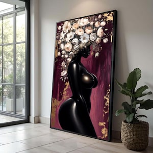 May include: A framed vertical wall art print featuring a silhouette of a dark-skinned figure in profile. The figure is adorned with a large, dense arrangement of white and cream-colored flowers on the head, set against a deep burgundy background.