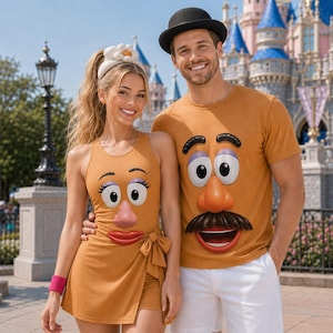 May include: A mustard yellow sleeveless wrap dress with a Mrs. Potato Head face graphic and a mustard yellow t-shirt with a Mr. Potato Head face graphic, featuring a black bowler hat, white shorts, and a white headband with a large flower.