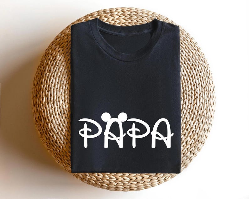 May include: Black t-shirt with a white graphic of Mickey Mouse ears and the word "PAPA" in a stylised font.