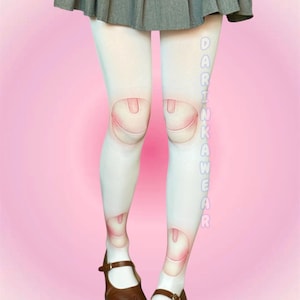 May include: White tights featuring a printed doll joint design at the knees and ankles, paired with a grey pleated skirt and brown Mary Jane shoes. The text DARINKAWEAR is printed vertically in light blue letters along the right leg of the tights.