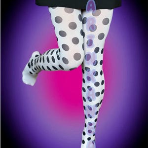 May include: White tights with large black polka dots. The tights are worn with a black skirt with large eyelets. The background is a gradient of purple and pink.