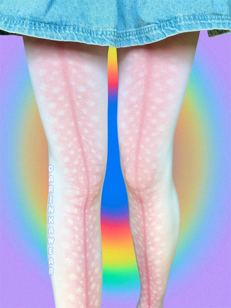 May include: White tights featuring a pink deer-like pattern with white spots and a vertical pink stripe running down the center of each leg. The text DARINKAWEAR is printed vertically in white letters on the side of the right leg below the knee.