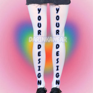 May include: White tights with the words "YOUR DESIGN" printed vertically in black on each leg. The tights are worn with black shoes. The background is a gradient of pink, purple, and blue.