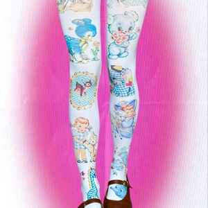 May include: White tights featuring a repeating pattern of vintage-style illustrations including blue teddy bears, a fawn in an oval frame, a child with a lamb, a blue elephant, and a small blue dinosaur, paired with brown split-toe shoes.