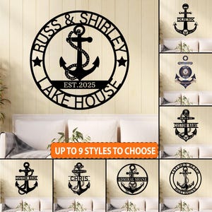 May include: Black metal lake house sign with an anchor design. The sign reads "RUSS & SHIRLEY LAKE HOUSE EST. 2025" in a circular frame. Additional anchor designs with customizable text are also shown.