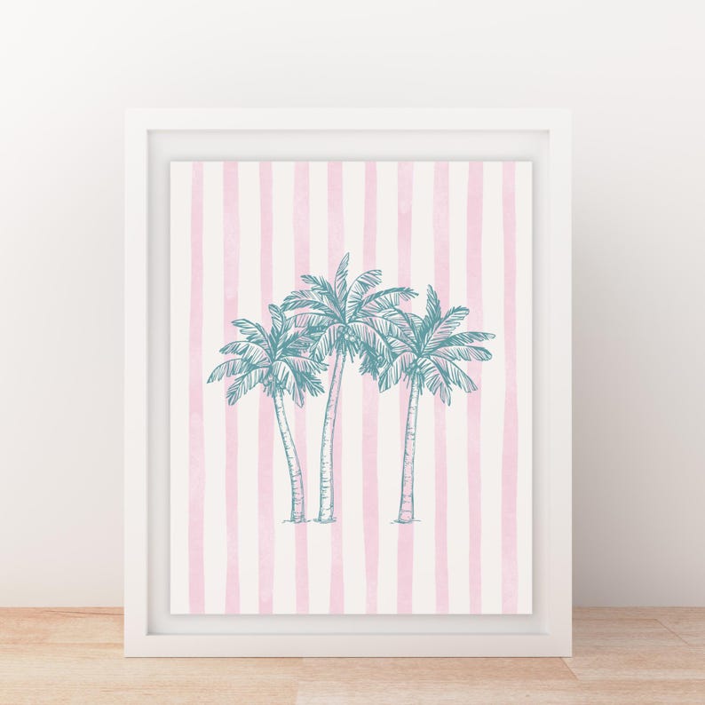 May include: Framed art print featuring three teal palm trees on a pink and white striped background. The artwork is encased in a white frame, creating a clean and modern aesthetic. This piece is perfect for adding a touch of tropical flair to any space.