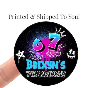 May include: A black round sticker with a colorful design for a 7th birthday. The design includes the number 6 and 7 in blue and pink, the name "Brixyn's", a star, and a smiling face.