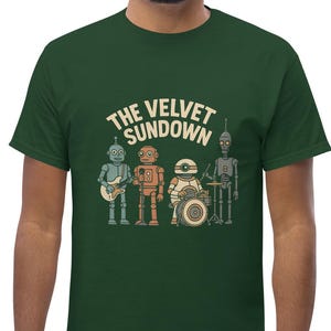 May include: Green t-shirt featuring a band of robot musicians. The text "THE VELVET SUNDOWN" is arched above the robot band. The robots are in various colors, playing instruments like a guitar and drums.