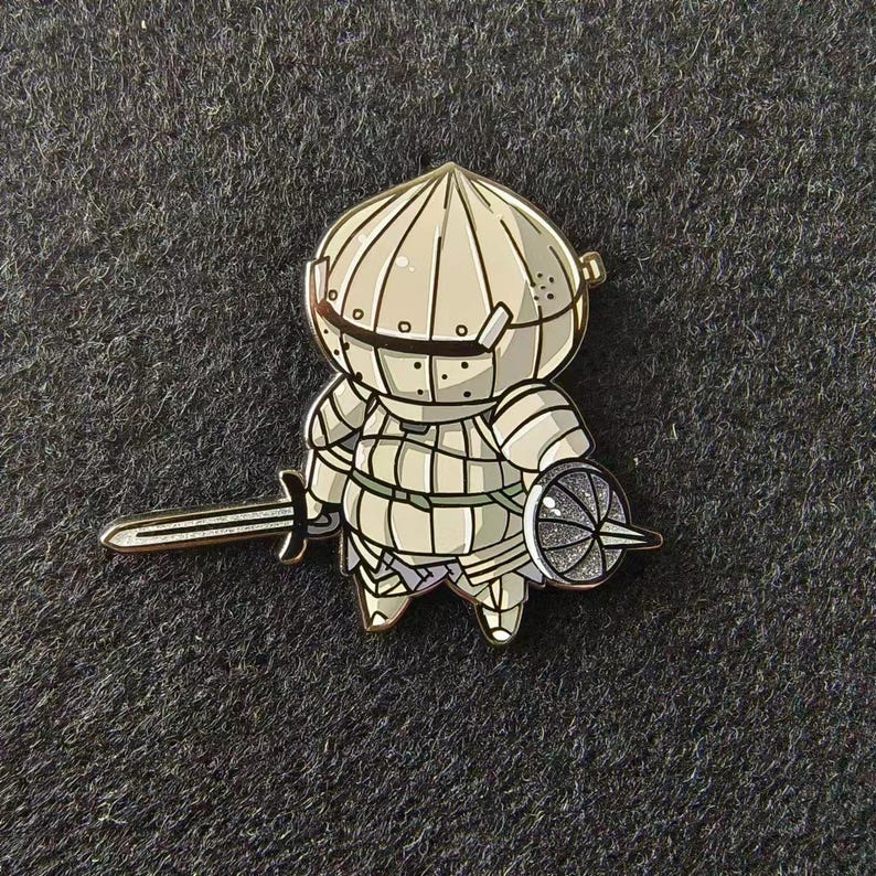 a pin with a cartoon character holding a sword