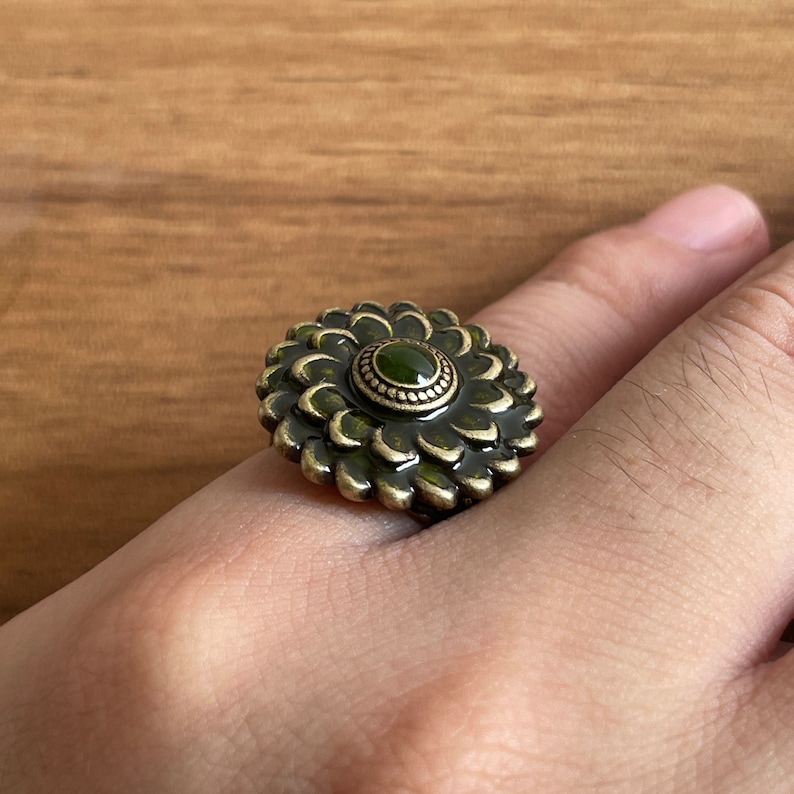 a person's hand with a ring on it