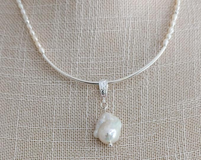 Baroque and Freshwater pearls.  Wear two different ways.  With or without the center Baroque! Elegant and simple!