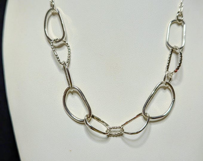 Sterling Silver Links:  Oh the feel of silver. Eight different designs of silver, all different lengths and shapes with an open link chain.