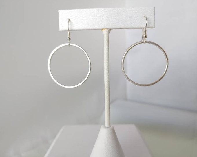 Dangling Hoop on French wires. Flattened round sterling wire hang from earwires. 1 1/4" drop. 1 1/4" wide.