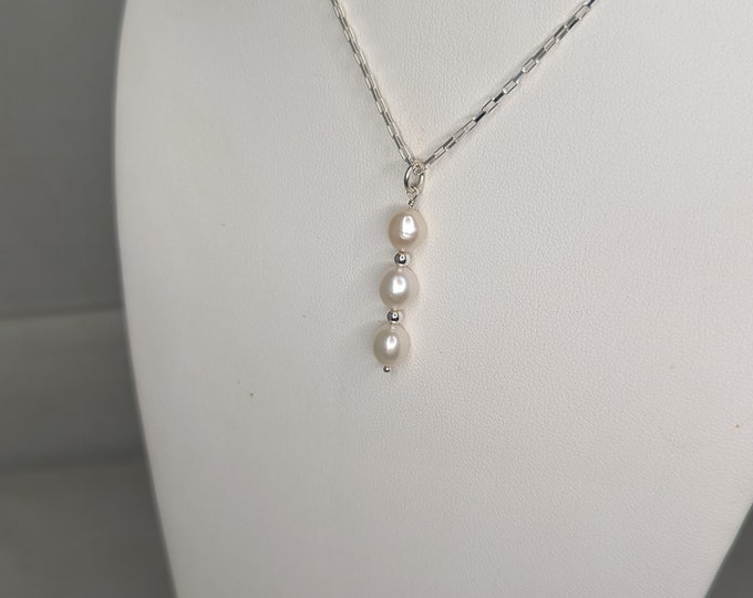 Freshwater pearl and sterling silver bead pendant.   Lobster claw clasp.