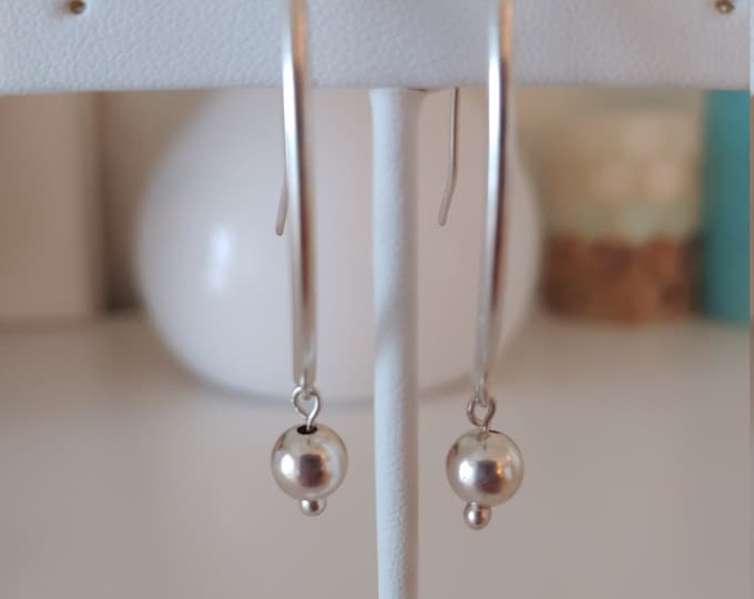 Seamless ball dangle earrings.  Balls hang from curved sterling silver tubes with self made earwires.  Lightweight,