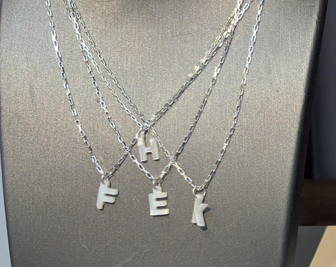 Mother of Pearl initial pendant on 18" sterling silver chain. F,H,K,M,P,S,W ONLY.  CLOSE OUT.