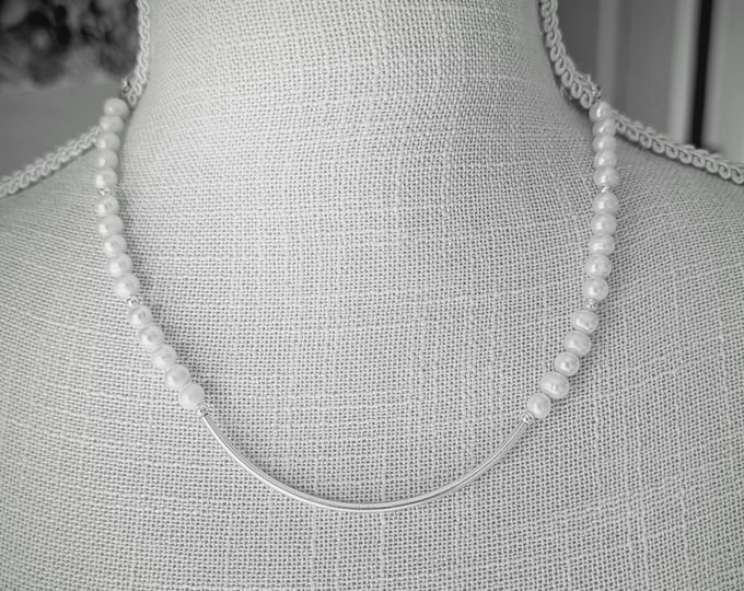 Freshwater pearls with sterling curved center focal.  Elegant and simple!