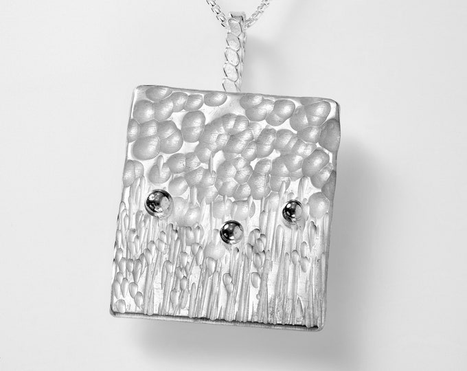 Flowers in the Field. sterling silver textured pendant reminiscent of flowers in a field with the sky. 30" chain