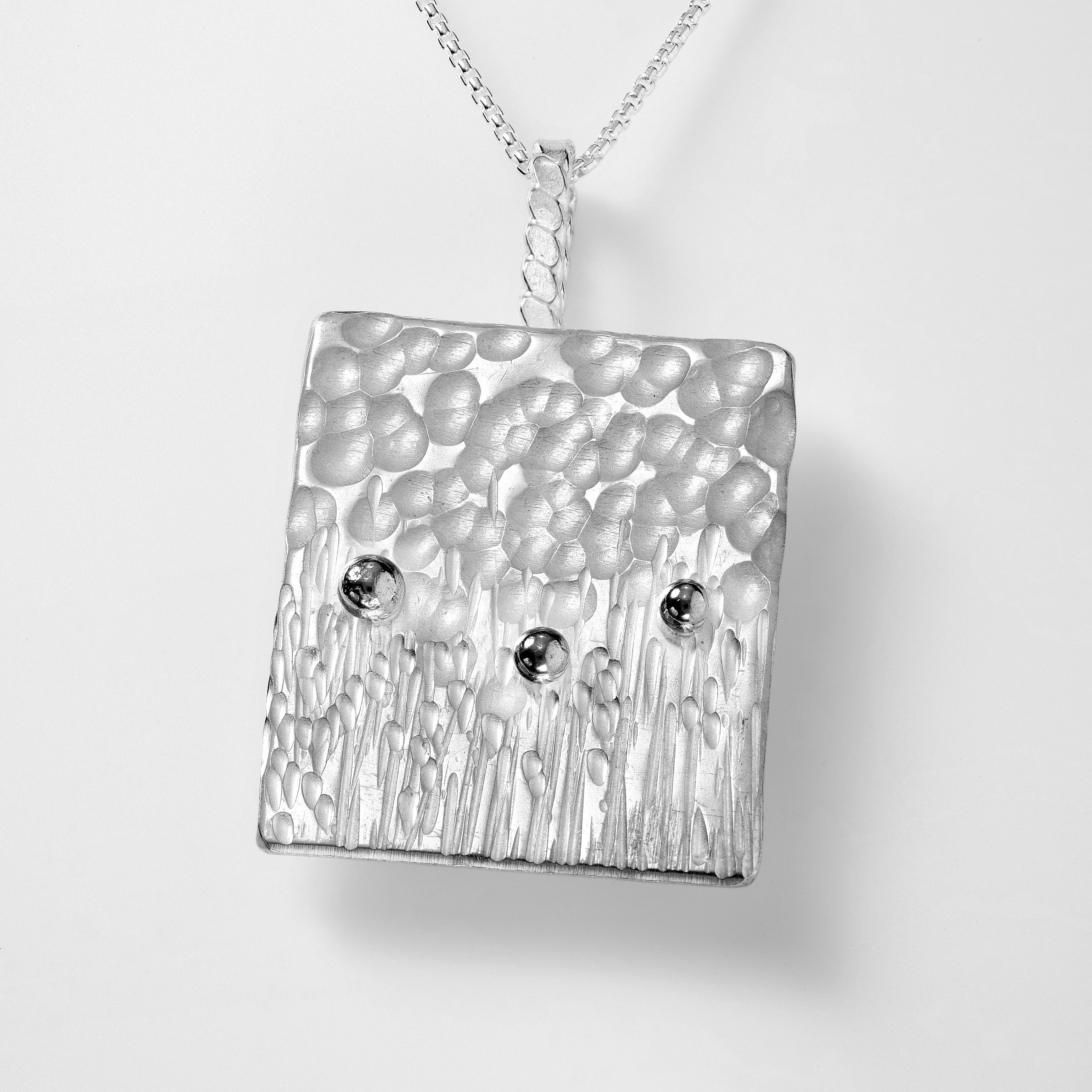 Flowers in the Field. sterling silver textured pendant reminiscent of