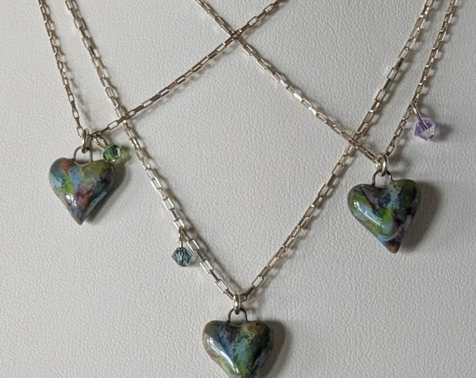 Adorable, petite Gaea made ceramic hearts.  Each with a coordinating crystal.  On patina sterling silver chain and components.