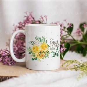 May include: White ceramic mug with a floral design featuring yellow roses and green leaves. The mug has the text "do small things with great love" in a mix of fonts. The mug is surrounded by purple flowers and greenery.