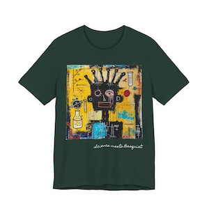 May include: A dark green short-sleeve t-shirt featuring a central graphic print with a stylized black figure, yellow background, and various scientific symbols. The text "Science meets Basquiat" is printed in white script below the graphic.