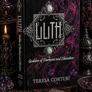 May include: A hardcover book titled "LILITH Goddess of Darkness and Liberation" by Teresa Cortubi. The book has a black cover with a decorative design in pink and purple. The title is in a stylized font, and the book is surrounded by other mystical items.