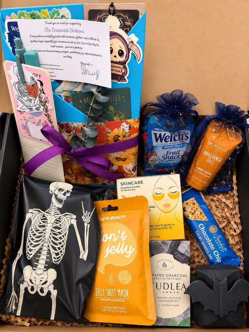 May include: A gift box containing a skeleton-printed pouch, a pineapple jelly sheet mask, a chocolate chip granola bar, a charcoal cleansing bar, a Spongelle hand cream, Welch's fruit snacks, a skincare eye mask, a pen, and a thank you note.