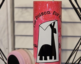 May include: A pink and white tumbler with a black silhouette of a giraffe with the text "the poison for kids is right. The po" on the front.