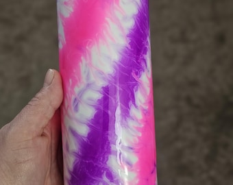 May include: A white tumbler with a pink and purple tie-dye design.