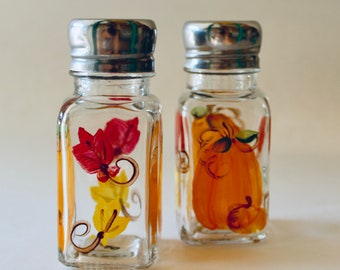 Hand painted Fall salt and pepper shakers.  Pumpkins and leaves.  Standard size.  Fall table decor.