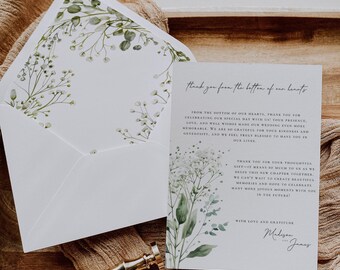 May include: A white thank you card with a floral design and the text "Thank you from the bottom of our hearts." The card is on a wooden surface with a gold wax seal.