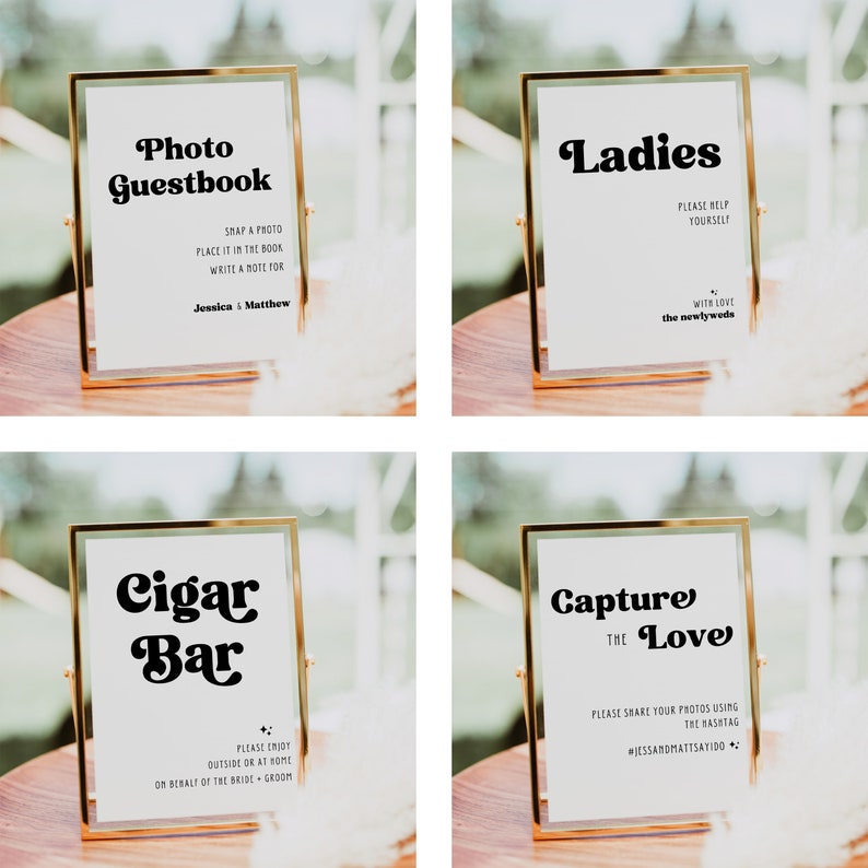 May include: Four gold-framed signs with white backgrounds and black text. The signs read "Photo Guestbook", "Ladies", "Cigar Bar", and "Capture the Love".