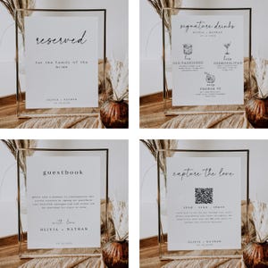 May include: Four framed wedding signs with gold trim and white backgrounds. The signs include text such as "reserved", "signature drinks", "guestbook", and "capture the love". Each sign has the names "Olivia & Nathan" and the date "18.10.2020".
