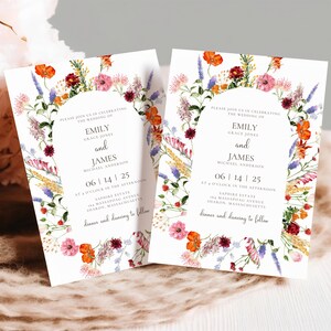 May include: Two floral wedding invitations with a wreath of watercolor flowers in shades of pink, orange, red, purple, and yellow. The text reads "Please join us in celebrating the wedding of Emily Grace Jones and James Michael Anderson 06 | 14 | 25 at 4 o'clock in the afternoon Sapphire Estate 184 Massapoag Avenue Sharon, Massachusetts dinner and dancing to follow"