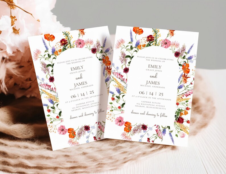 May include: Two floral wedding invitations with a wreath of watercolor flowers in shades of pink, orange, red, purple, and yellow. The text reads "Please join us in celebrating the wedding of Emily Grace Jones and James Michael Anderson 06 | 14 | 25 at 4 o'clock in the afternoon Sapphire Estate 184 Massapoag Avenue Sharon, Massachusetts dinner and dancing to follow"