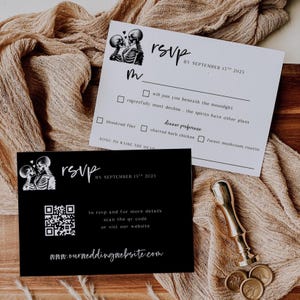 May include: Black and white RSVP cards with skeleton couple illustrations. One card is black with a QR code and website address. The other is white with RSVP details, including a deadline and dinner preferences.