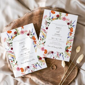 May include: Wedding invitation with a floral design featuring a wreath of wildflowers in shades of pink, purple, orange, and red. The text reads "Please join us in celebrating the wedding of Emily Grace Jones and James Michael Anderson 06 | 14 | 25 at o'clock in the afternoon Sapphias Estate Sharon, Massachusetts dinner and dancing to follow"