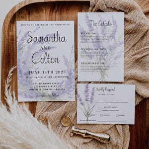 May include: Wedding invitation suite with lavender floral designs. The invitation card features the names Samantha and Colton, the date June 14th, 2025, and the location The Biltmore Estate. The details card includes information about the reception, accommodations, transportation, and a RSVP section.