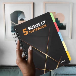 May include: A black spiral notebook with gold accents and a black and white geometric design. The notebook has five subject dividers with coloured tabs. The front cover has the text "5 Subject Notebook" and the number "5" in orange. The bottom right corner of the notebook has the text "VABE UK".