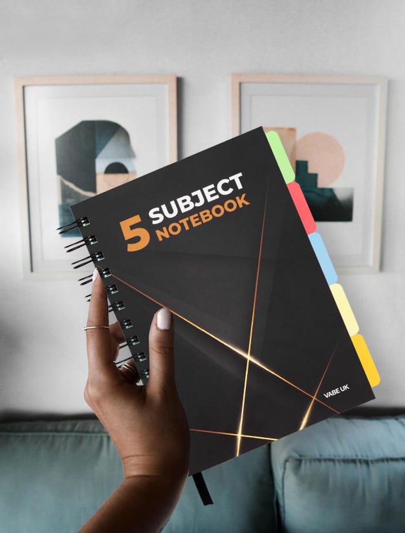 May include: A black spiral notebook with gold accents and a black and white geometric design. The notebook has five subject dividers with coloured tabs. The front cover has the text "5 Subject Notebook" and the number "5" in orange. The bottom right corner of the notebook has the text "VABE UK".
