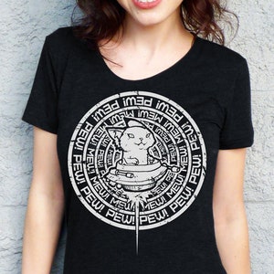 May include: Black t-shirt with a white graphic of a cat in a spaceship surrounded by the words "pew!" and "mew!" repeated in a circle.