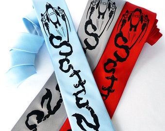 May include: Three silk neckties with a black and white graphic print of a plane flying over clouds. The ties are in light blue, gray, and red.